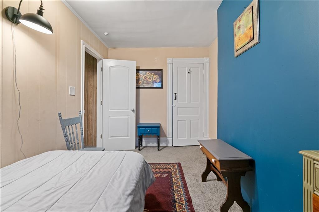 1630 Poplar Avenue Braddock, PA 15104 - Photo 17 of 25 a bedroom with a bed and a table in it