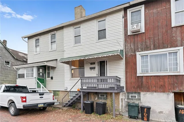 a view of a large house with wooden stairs