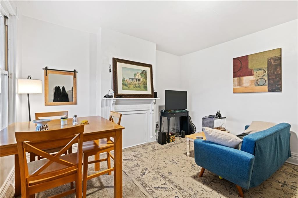 1630 Poplar Avenue Braddock, PA 15104 - Photo 6 of 25 a living room with furniture a flat screen tv and a dining table