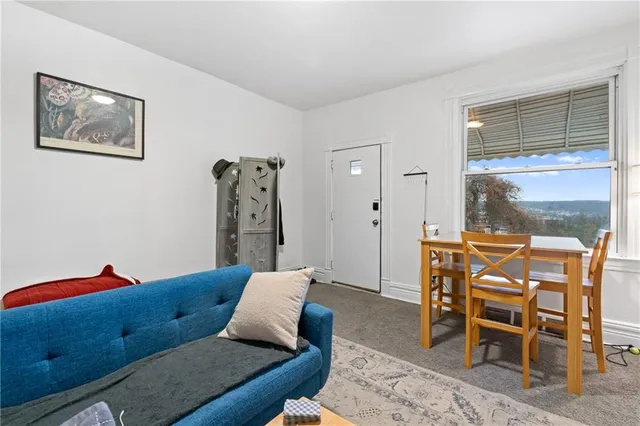 a living room with furniture and a lamp