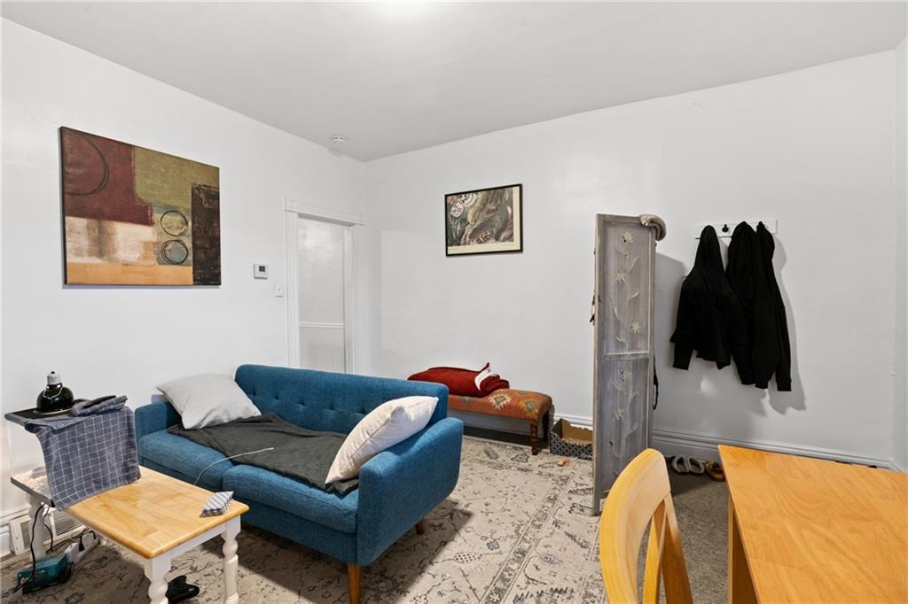 1630 Poplar Avenue Braddock, PA 15104 - Photo 8 of 25 a living room with furniture and a lamp