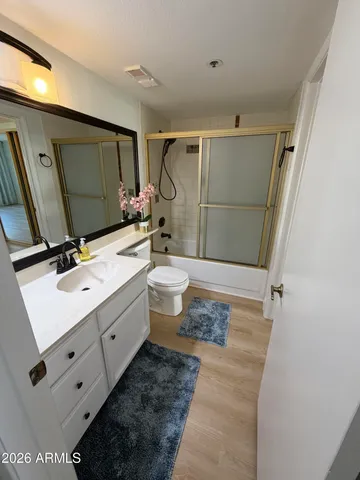 a bathroom with a double vanity sink toilet mirror and tub
