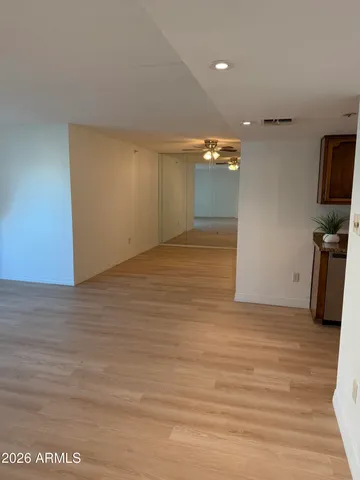 a view of a room with wooden floor and a sink