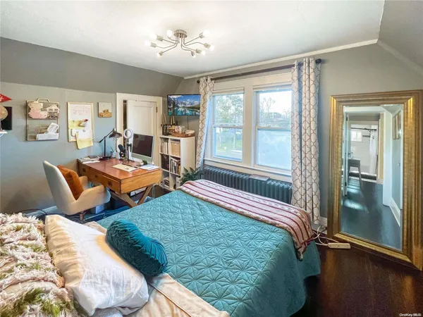 a bedroom with bed and window