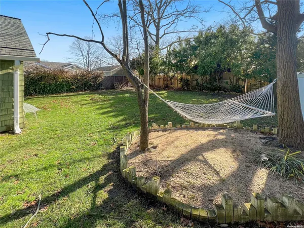 a view of a backyard with large trees