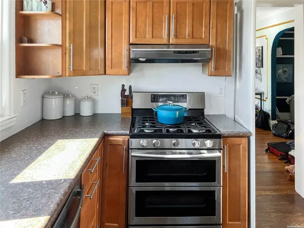 a kitchen with stove and cabinets