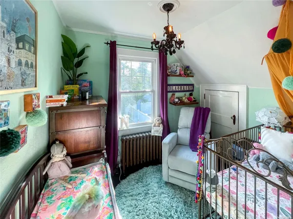 a bedroom with furniture and a chandelier