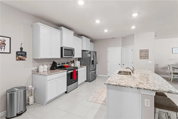 a kitchen with a sink stove and refrigerator