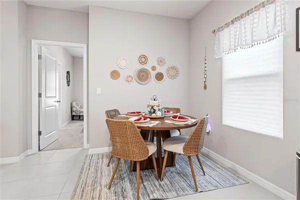a view of a dining room with furniture and a window