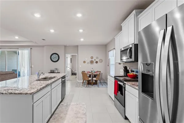 a kitchen with stainless steel appliances granite countertop a refrigerator and a sink
