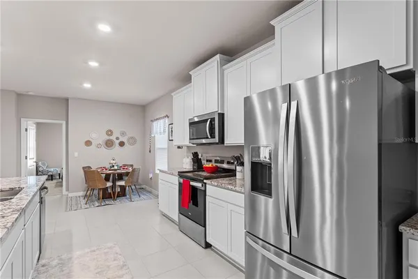 a kitchen with stainless steel appliances a refrigerator and a stove top oven