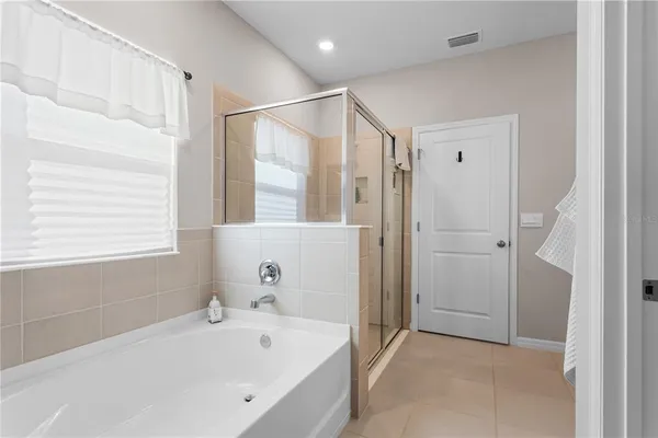 a bathroom with a bathtub and a shower