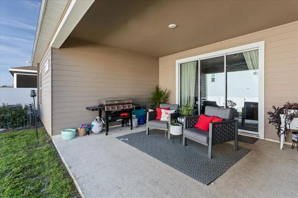 a view of a patio with table and chairs and potted plants