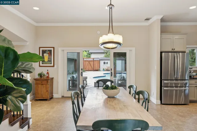 a view of a dining room with furniture and a chandelier