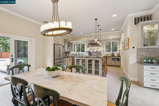 a kitchen with kitchen island granite countertop a stove a sink a center island and cabinets
