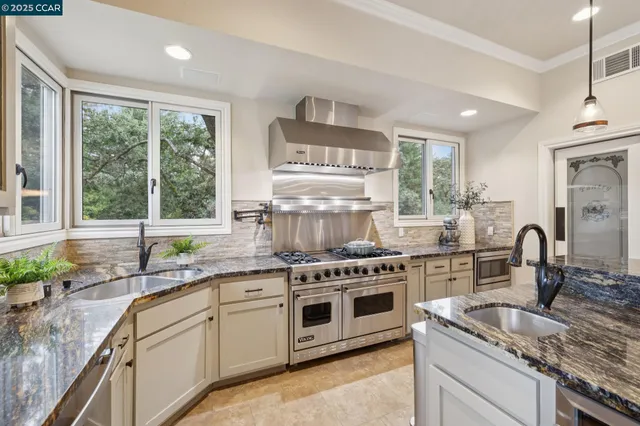 a kitchen with a sink stove and cabinets