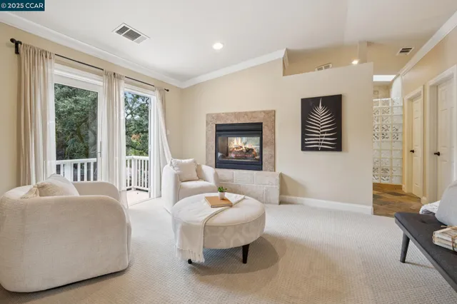 a bathroom with a granite countertop sink vanity mirror next to a window
