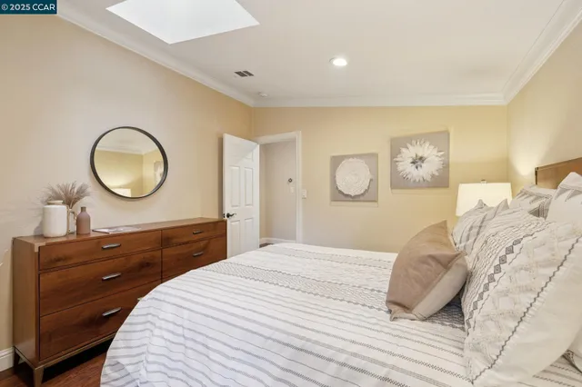 a front view of a house with garden and sitting area