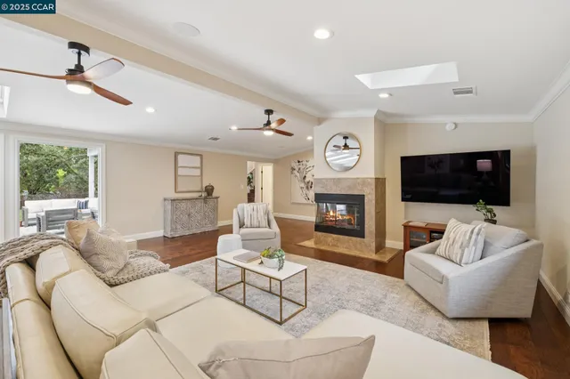 a living room with furniture a flat screen tv and a fireplace