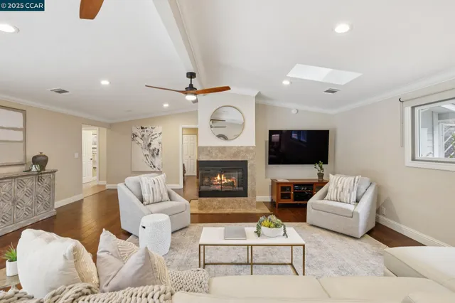 a living room with furniture a fireplace and a flat screen tv
