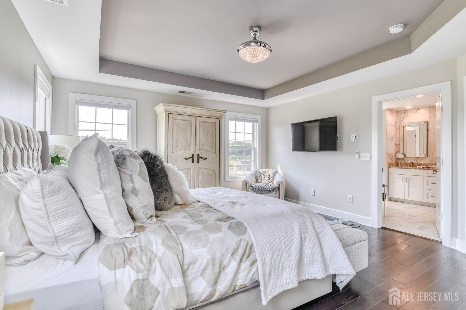 1529 Paxton Lane Monroe Township, NJ 08831 - Photo 11 of 36 a bedroom with a large bed and a tv