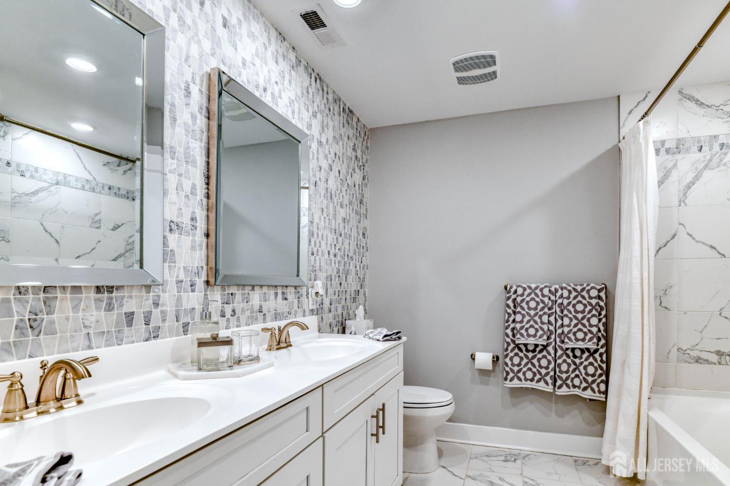 1529 Paxton Lane Monroe Township, NJ 08831 - Photo 13 of 36 a bathroom with a sink a toilet and shower