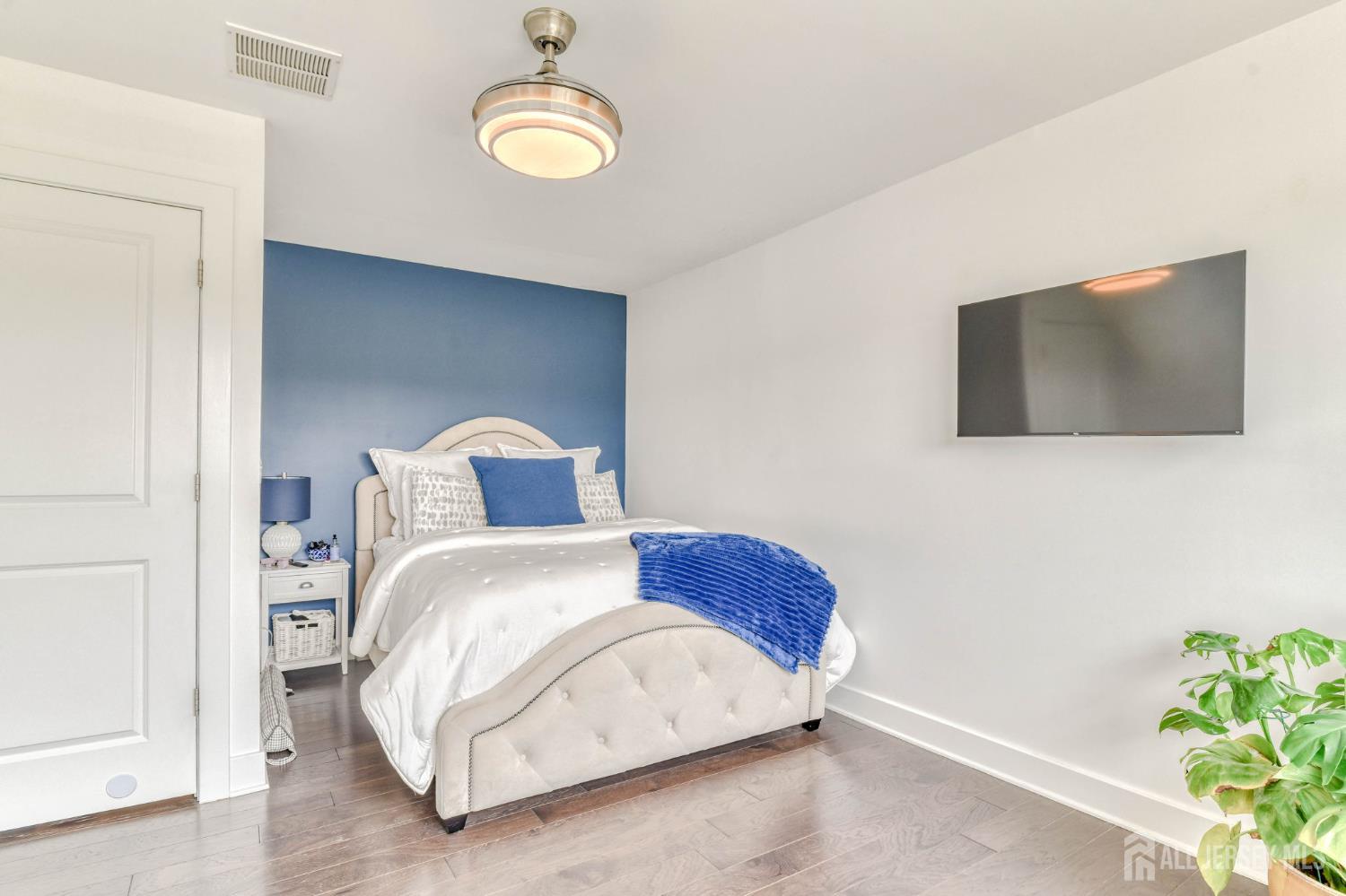 1529 Paxton Lane Monroe Township, NJ 08831 - Photo 15 of 36 a bedroom with a bed and a flat screen tv