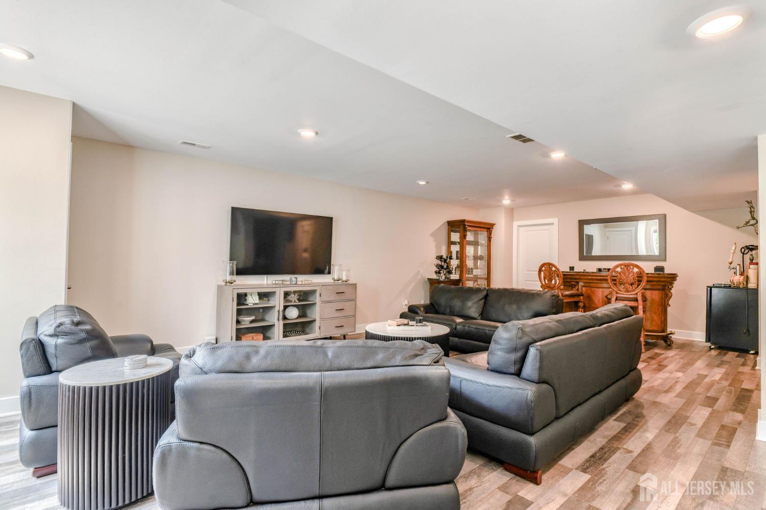 1529 Paxton Lane Monroe Township, NJ 08831 - Photo 21 of 36 a living room with furniture and a flat screen tv