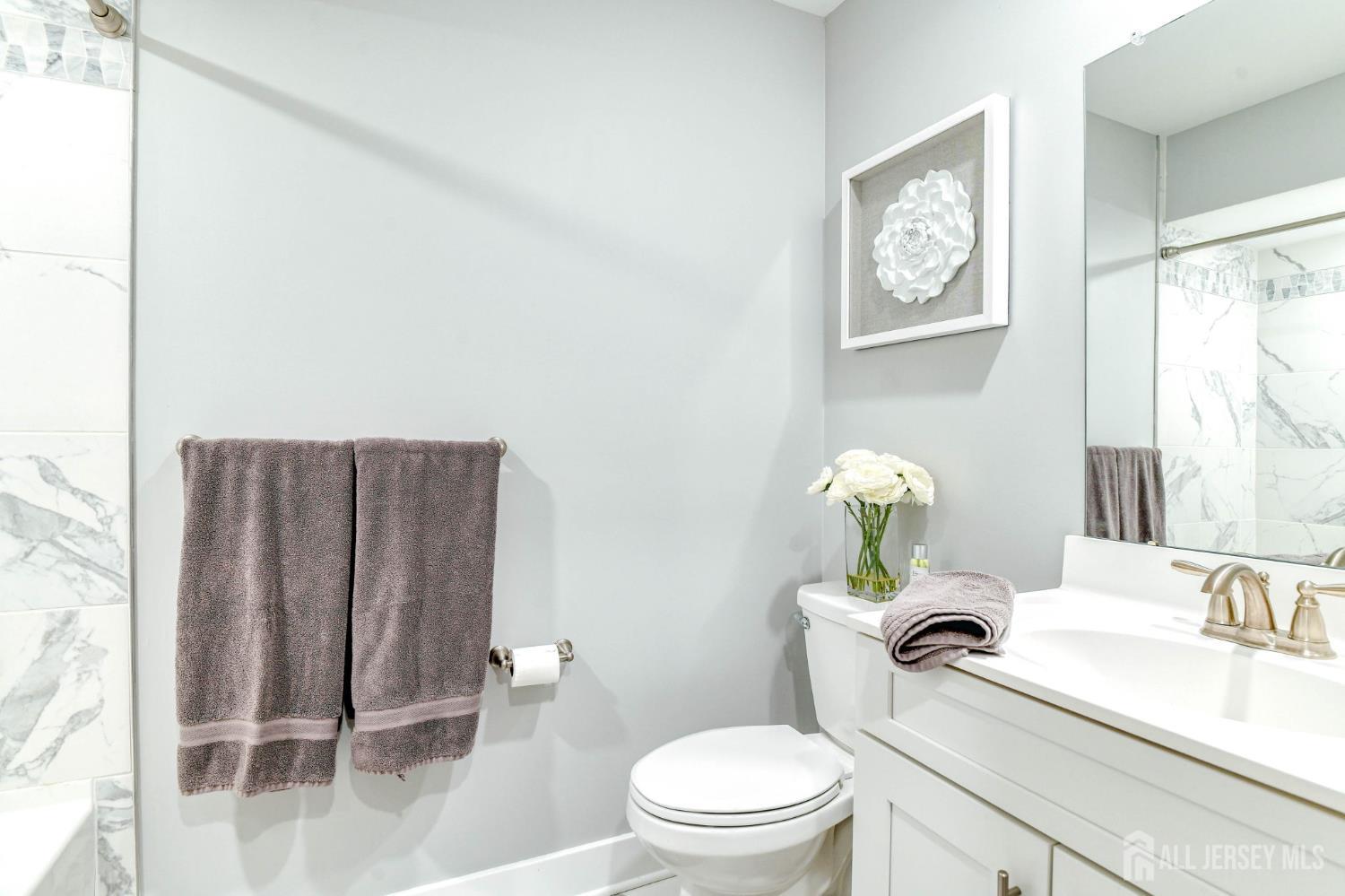 1529 Paxton Lane Monroe Township, NJ 08831 - Photo 25 of 36 a white toilet sitting next to a bathroom sink