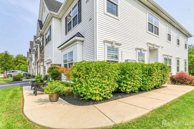 a kitchen with white cabinets and appliances