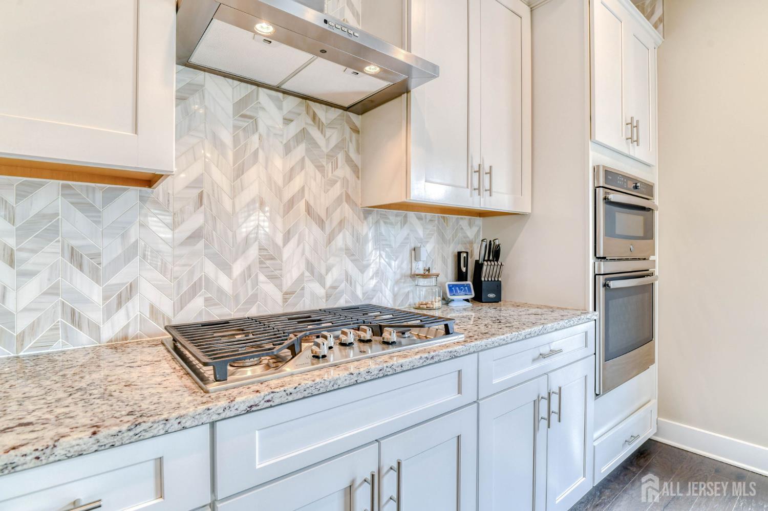 1529 Paxton Lane Monroe Township, NJ 08831 - Photo 5 of 36 a kitchen with white cabinets and appliances