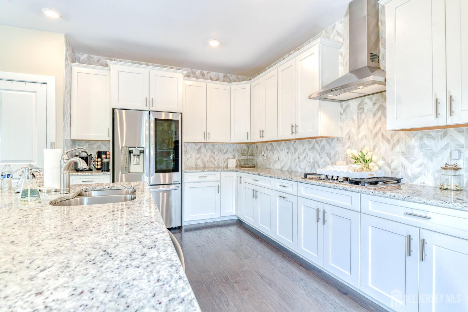 1529 Paxton Lane Monroe Township, NJ 08831 - Photo 8 of 36 a kitchen with granite countertop a refrigerator sink stove and cabinets