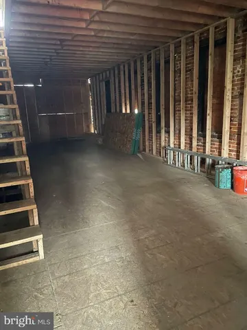 a room with water heater and wooden cabinets