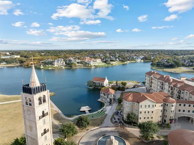 an aerial view of a house with outdoor space and lake view in back