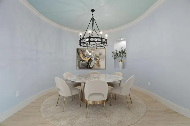 a view of a dining room with furniture wooden floor and a chandelier