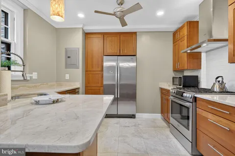 a kitchen with appliances cabinets and a window