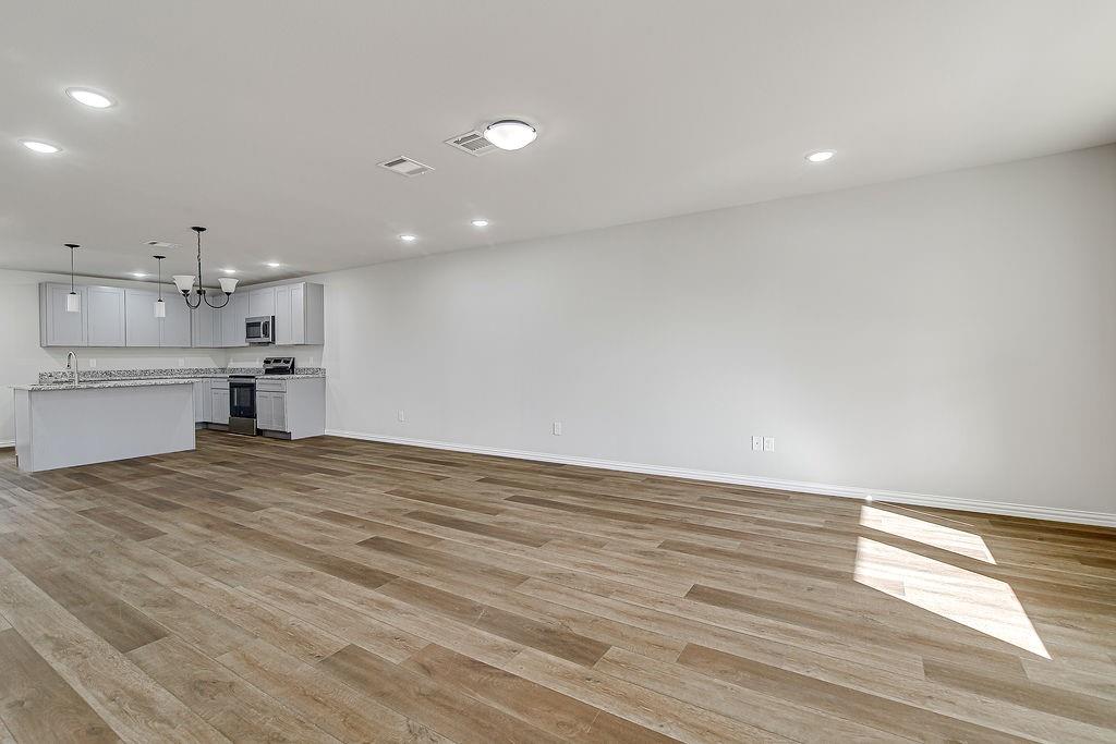 333 North Field Street Burleson, TX 76028 - Photo 23 of 35 a view of kitchen and kitchen with wooden floor