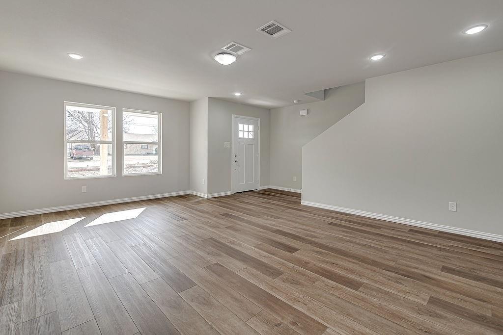 333 North Field Street Burleson, TX 76028 - Photo 25 of 35 an empty room with wooden floor and windows