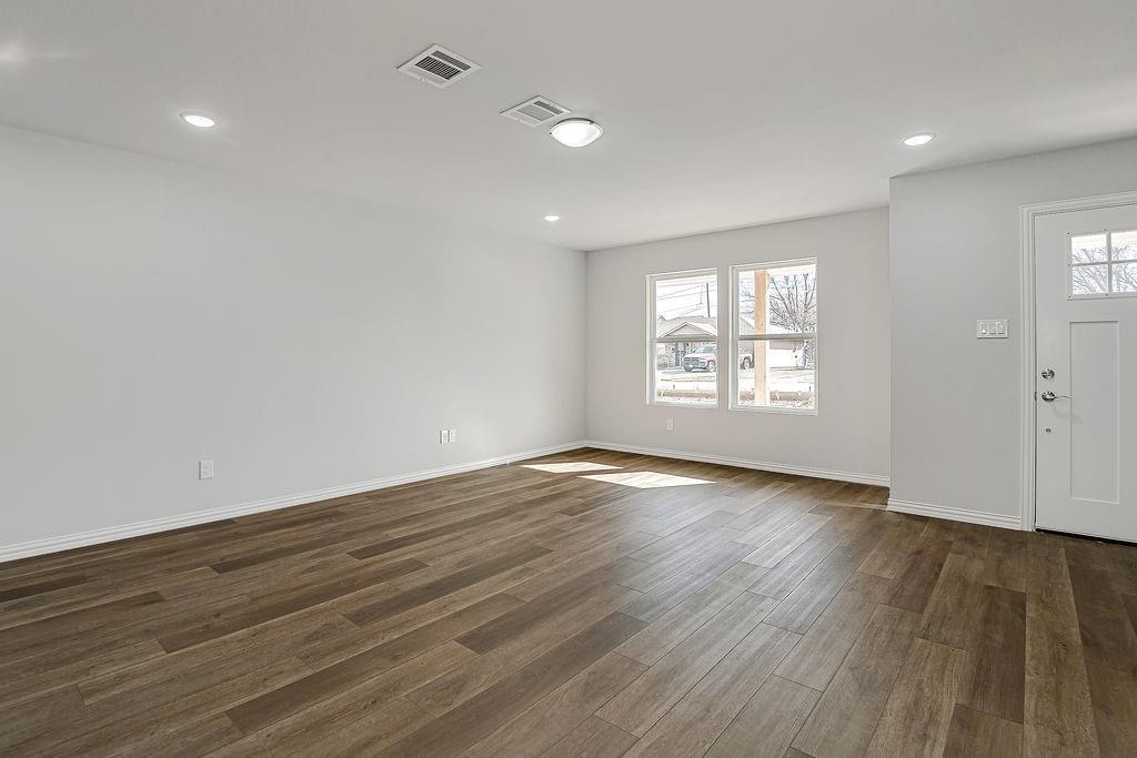 333 North Field Street Burleson, TX 76028 - Photo 26 of 35 an empty room with wooden floor and windows