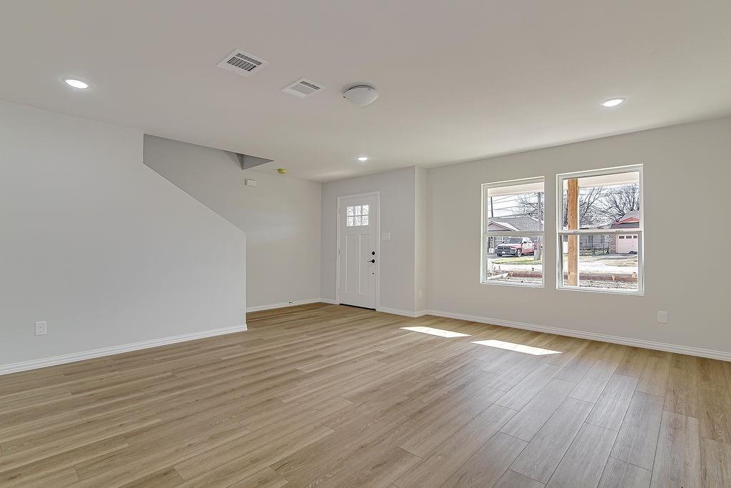 333 North Field Street Burleson, TX 76028 - Photo 3 of 35 an empty room with wooden floor and windows