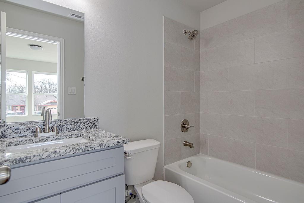 333 North Field Street Burleson, TX 76028 - Photo 35 of 35 a bathroom with a granite countertop toilet a sink and a bathtub