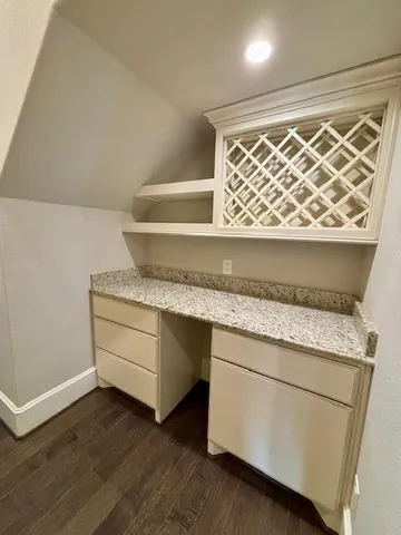 a utility room with granite countertop cabinets washer and dryer