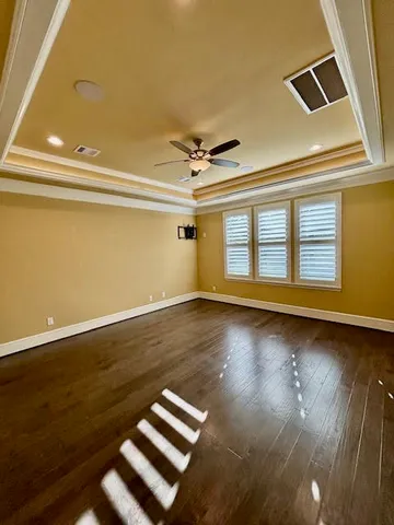 a view of a room with wooden floor and window