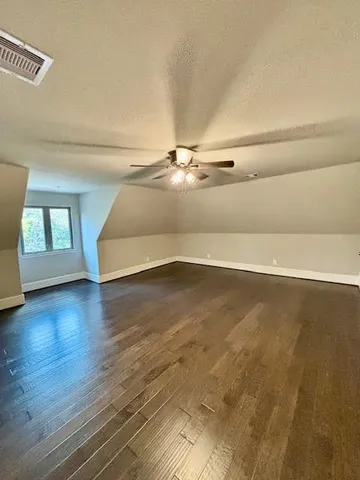 a view of a room with wooden floor and window