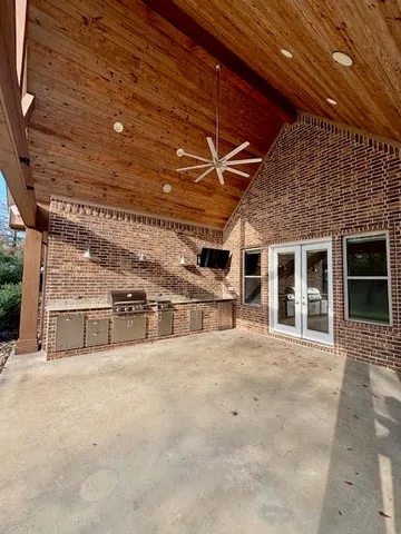 a kitchen with stainless steel appliances granite countertop a sink and a stove