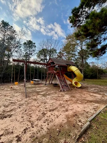 a view of a backyard with a slide and a fire pit