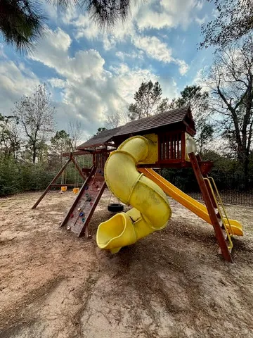 a view of outdoor space with playground and green space
