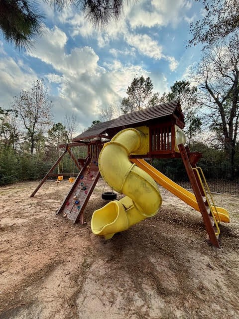 8970 Navigation Circle Montgomery, TX 77316 - Photo 45 of 47 a view of a backyard with a slide and a fire pit
