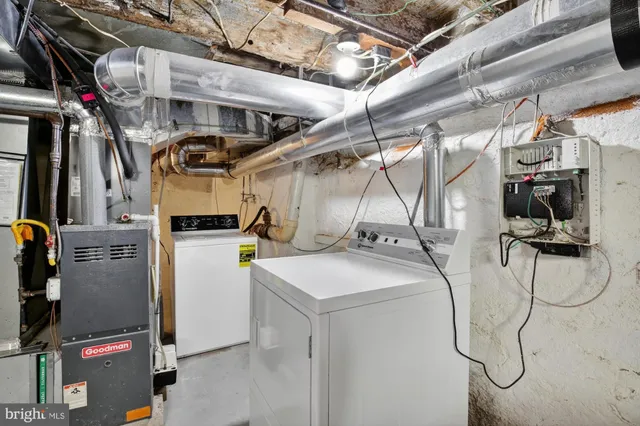 a utility room with multiple dryer and washer