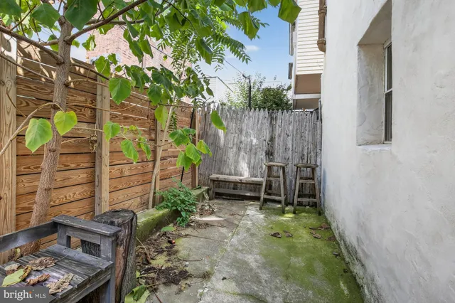 a backyard of a house with outdoor seating